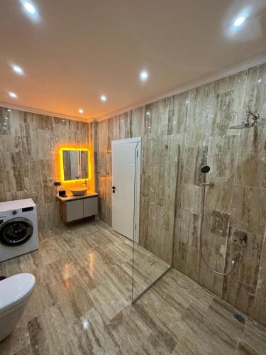 a bathroom with a shower and a toilet and a sink at Kalkan da Vaıllant Villa in Kaş