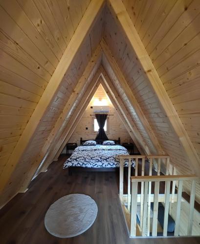 a bed in the middle of a attic at Cottage MIRNI RAJ in Jajce