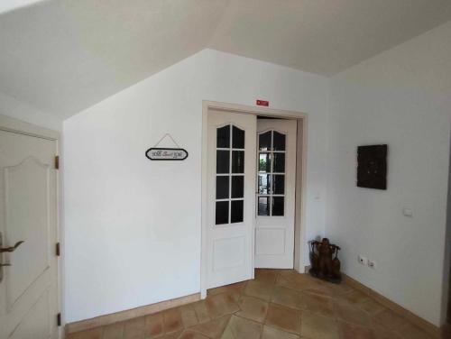 an empty room with a white door and a window at Albufeira INN - Mulatinho V3 in Olhos de Água