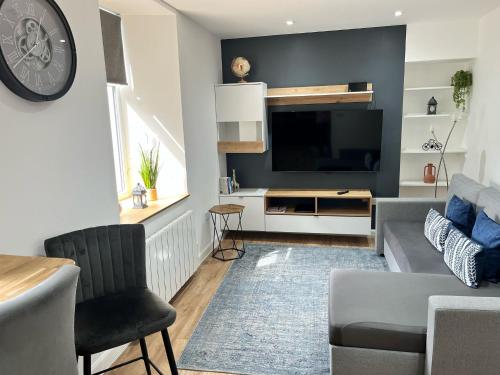 a living room with a couch and a tv at 51 Innes Street Apartment in Inverness