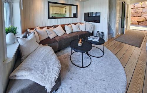a living room with a couch and a table at 3 Bedroom Stunning Home In Holmsbu in Holmsbu