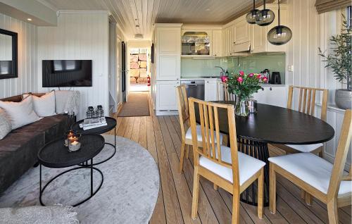 a kitchen and living room with a table and a couch at 3 Bedroom Stunning Home In Holmsbu in Holmsbu
