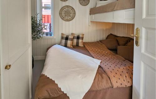 a bed in a small room with a window at 3 Bedroom Stunning Home In Holmsbu in Holmsbu