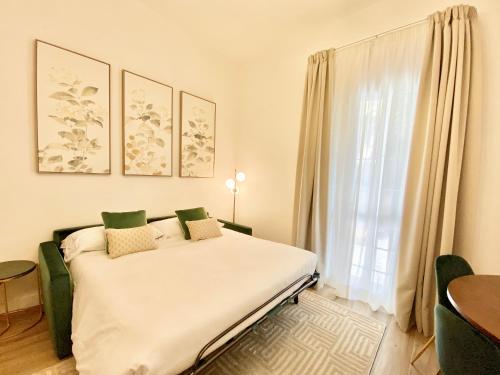 a bedroom with a bed and a large window at Mazzini 34 Collection in Florence