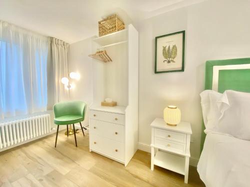 a bedroom with a bed and a chair and a desk at Mazzini 34 Collection in Florence