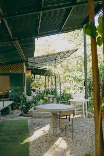 a picnic table and a bench under a canopy at Chilamate Rainforest Beach Retreat in Nosara