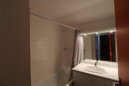 une salle de bain avec un lavabo et un miroir dans l'établissement Gîte de Dom, à La Salvetat-sur-Agout