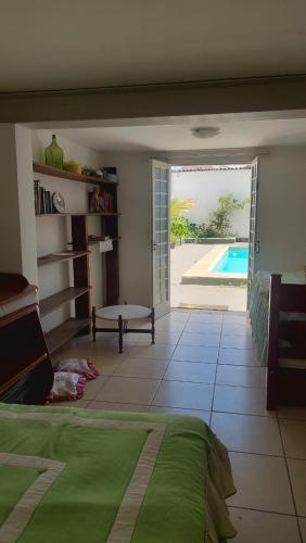 a bedroom with a bed and a view of a pool at Casa em Belo Horizonte - Pampulha in Belo Horizonte