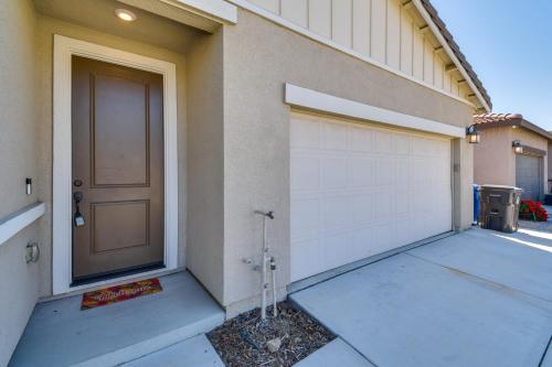 a building with a garage door and a driveway at WFH-Friendly Getaway with Yard in Manteca! in Manteca