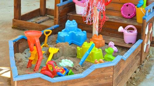 a toy sandbox with toys in the sand at Rigoletto Cilento with private garden and pool in Eredita