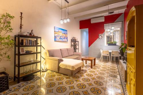 a living room with a couch and a table at Quiet double, twin or triple room with private bathroom, not ensuite in Sliema