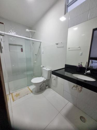 a bathroom with a shower and a toilet and a sink at Casa na praia de Tamandaré in Tamandaré