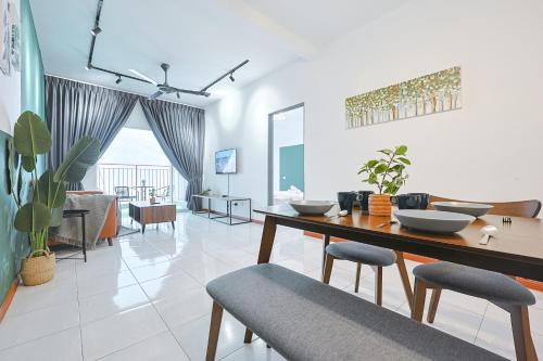a living room with a dining table and chairs at Elegant Studio Escape at Emerald Avenue Cameron Clover Home 4-03 in Brinchang