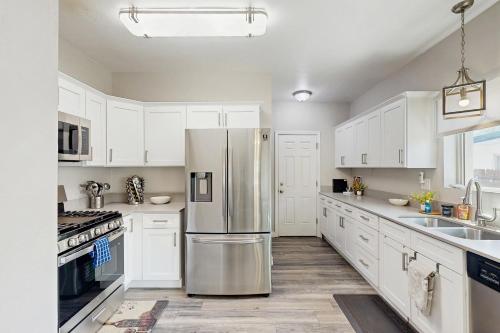 a kitchen with white cabinets and a stainless steel refrigerator at Sam Hughes on 6th in Tucson