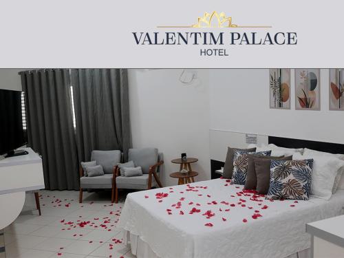 a bedroom with a bed with red flowers on it at Valentim Palace Hotel in Valentim Gentil