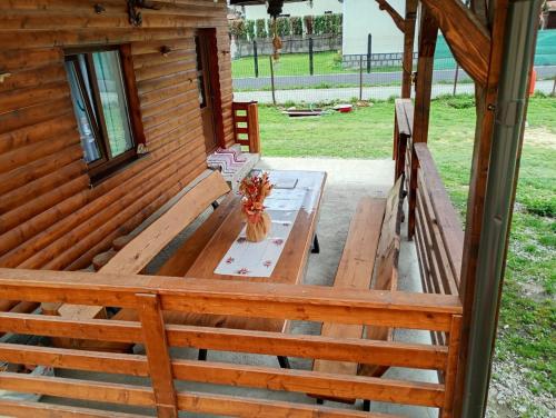a picnic table on the porch of a cabin at Casuta Adelina Borsa in Borşa
