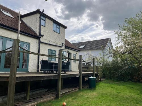 a wooden deck in front of a house at Homely holiday house in central Sevenoaks in Kent