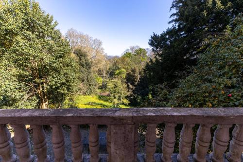 a stone railing with a view of a garden at Il Casale Di Villa Rossi in Lucca