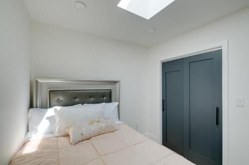 a bedroom with a bed with a black door at 4 Mi to Smithsonian Museums Modern DC Condo! in Washington