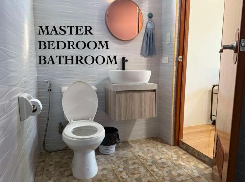 a bathroom with a white toilet and a sink at Blue Horizon in Bantayan Island