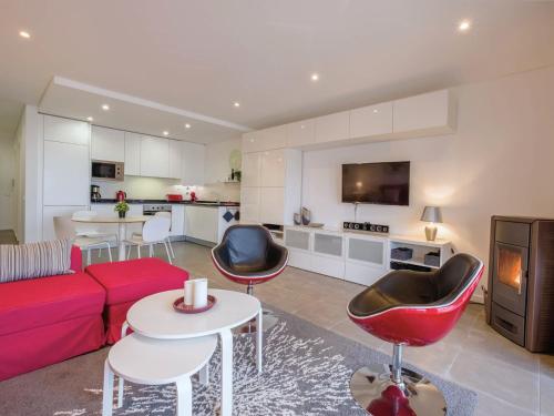 a living room with a red couch and red chairs at Cazenn Nazaré - Apartment Z in Nazaré