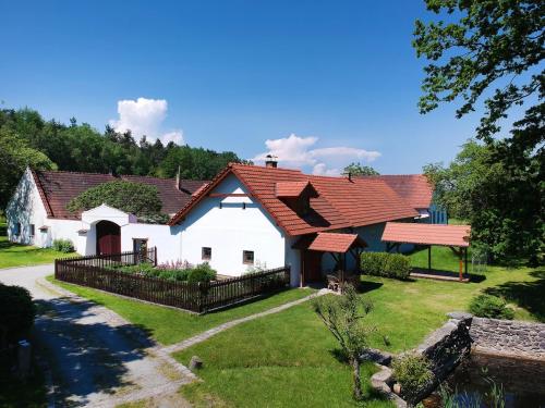 a large white house with a red roof at Chaloupka Větrník na samotě u lesa in Římov