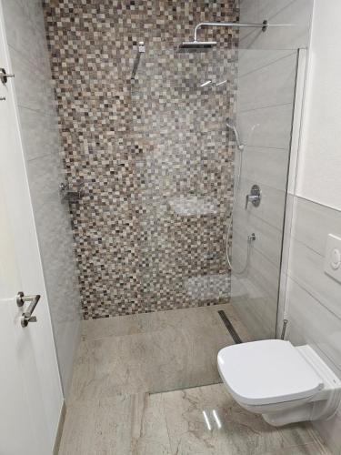 a bathroom with a shower with a toilet and a sink at Villa BOTIĆ in Trogir