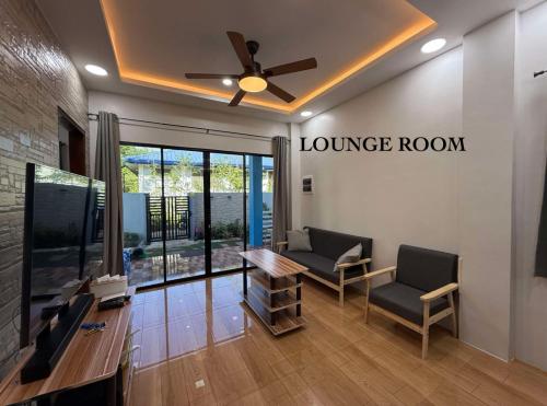 a waiting room with two chairs and a ceiling fan at Blue Horizon in Bantayan Island