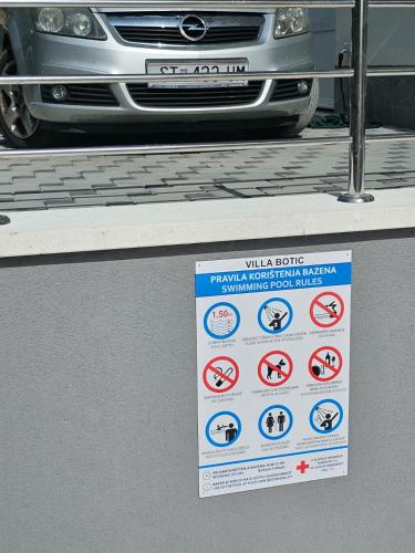 a sign in front of a car withbidden signs on it at Villa BOTIĆ in Trogir