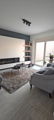 a living room with a bed and a fireplace at holiday home Zonnestraal in Zonhoven