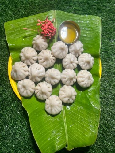 a plate of dumplings on a banana leaf at Sea Esta Resort - Kashid Beach in Kashid