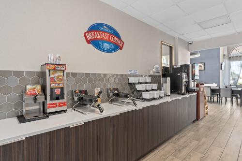 a fast food restaurant with a sign on the wall at Baymont by Wyndham Orlando East in Orlando