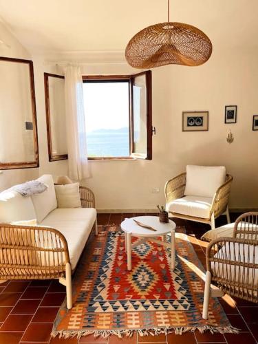 a living room with a couch and two chairs at Villa vista mare a Bosa in Magomadas