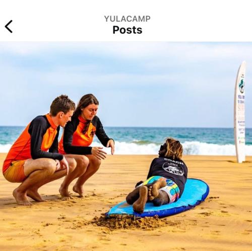 a group of people sitting on the beach at Barefoot Bungalow Hikka in Hikkaduwa