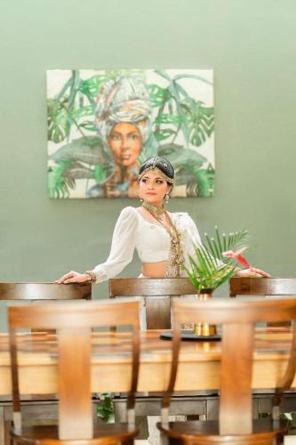 a woman standing behind a table in a room at Barefoot Bungalow Hikka in Hikkaduwa