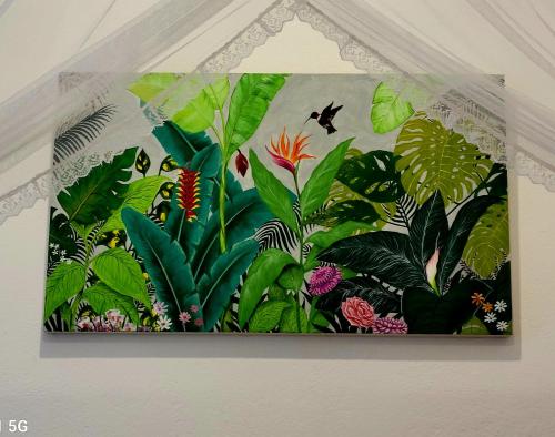 a picture of a jungle mural on a wall at Barefoot Bungalow Hikka in Hikkaduwa