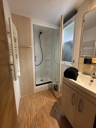 une salle de bain avec douche et lavabo dans l'établissement Parc Résidentiel à La Cotinière, Piscine, proche Plage, Nature & Calme, à La Cotinière