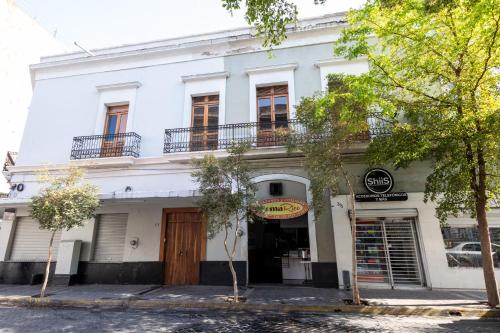 a white building with a wooden door and windows at Casa Araiza in Guadalajara