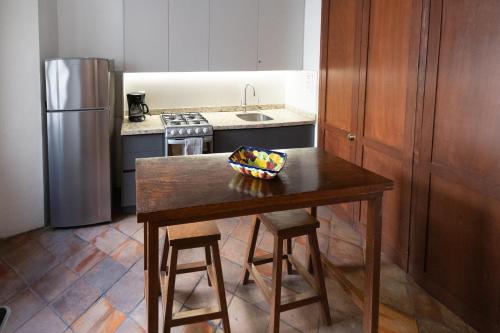 a kitchen with a table with a bowl of fruit on it at Casa Araiza in Guadalajara