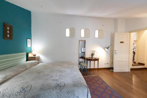 a bedroom with a large bed and a blue wall at Il Casale Di Villa Rossi in Lucca