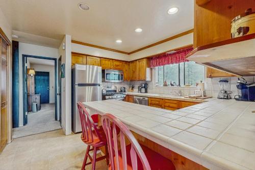 a kitchen with wooden cabinets and a white refrigerator at Tallac Views Getaway in South Lake Tahoe