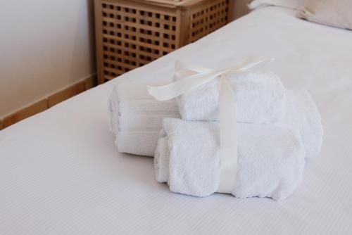 a pile of towels sitting on top of a bed at Villa Da Vinci Luxury Panoramic Apartments - Taormina rooms collection in Taormina