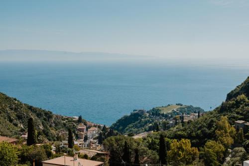 a view of the ocean from a hill at Villa Da Vinci Luxury Panoramic Apartments - Taormina rooms collection in Taormina