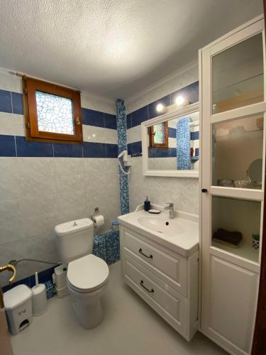 a bathroom with a white toilet and a sink at Georgia's house in Nikiti
