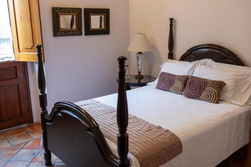 a bedroom with a large bed with a wooden frame at Casa Araiza in Guadalajara