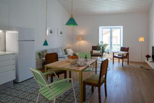 a kitchen and living room with a table and chairs at Vila Marta - Garajau in Vila Franca do Campo