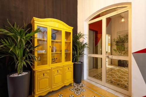 a yellow cabinet and a mirror in a room at Quiet double ensuite room in Sliema