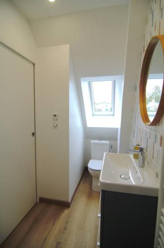 a bathroom with a sink and a toilet and a window at Le Bateau Bleu avec vue sur mer in Criel-sur-Mer