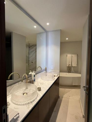 a bathroom with two sinks and a large mirror at Luxury Villa in Punta Mita in Higuera Blanca