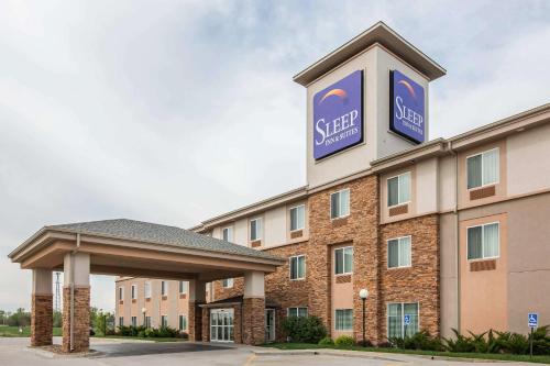 a hotel with a sign for a sleep inn at Sleep Inn & Suites Haysville - Wichita South in Haysville